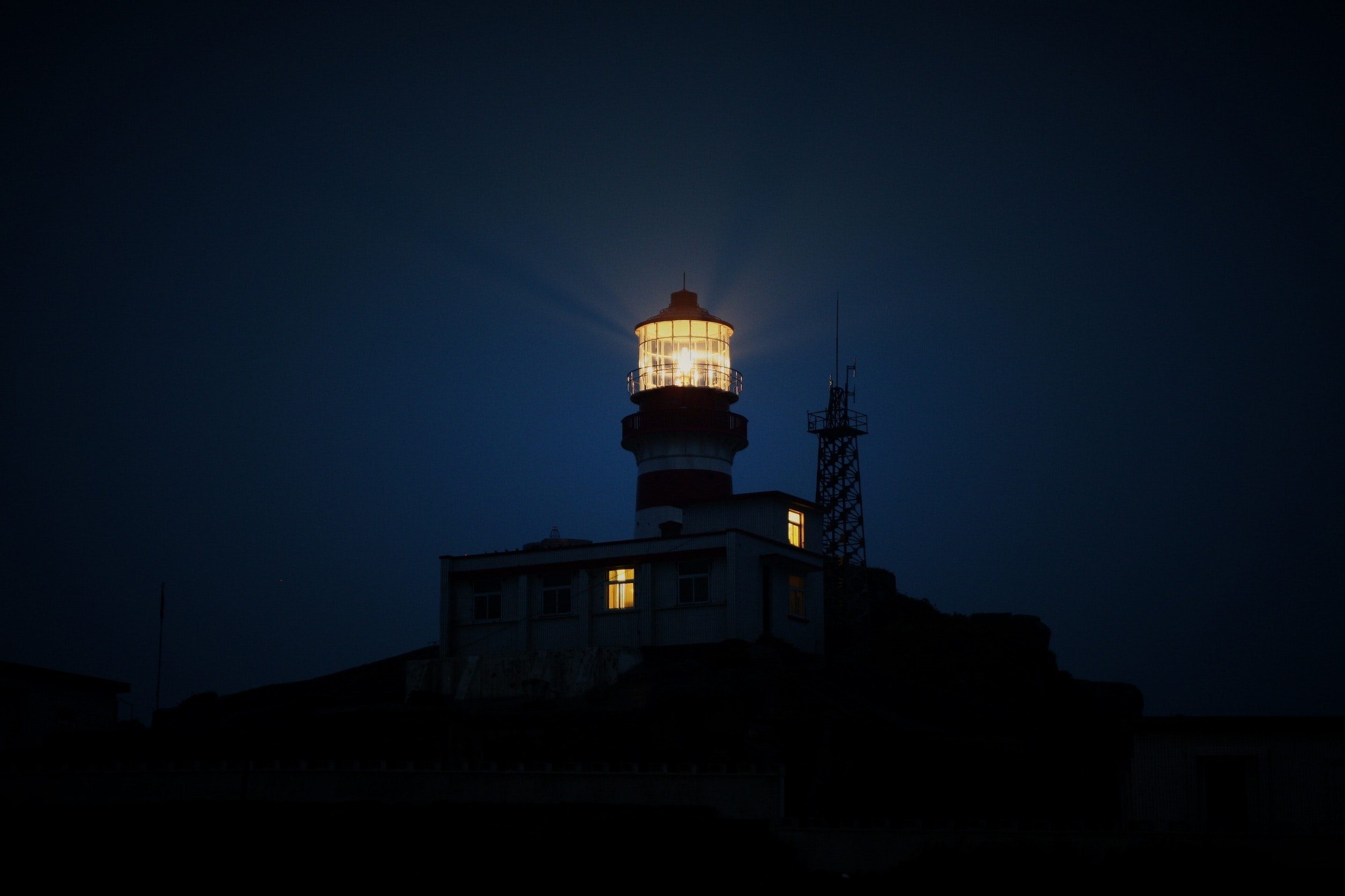 lighthouse-during-night-time-510848