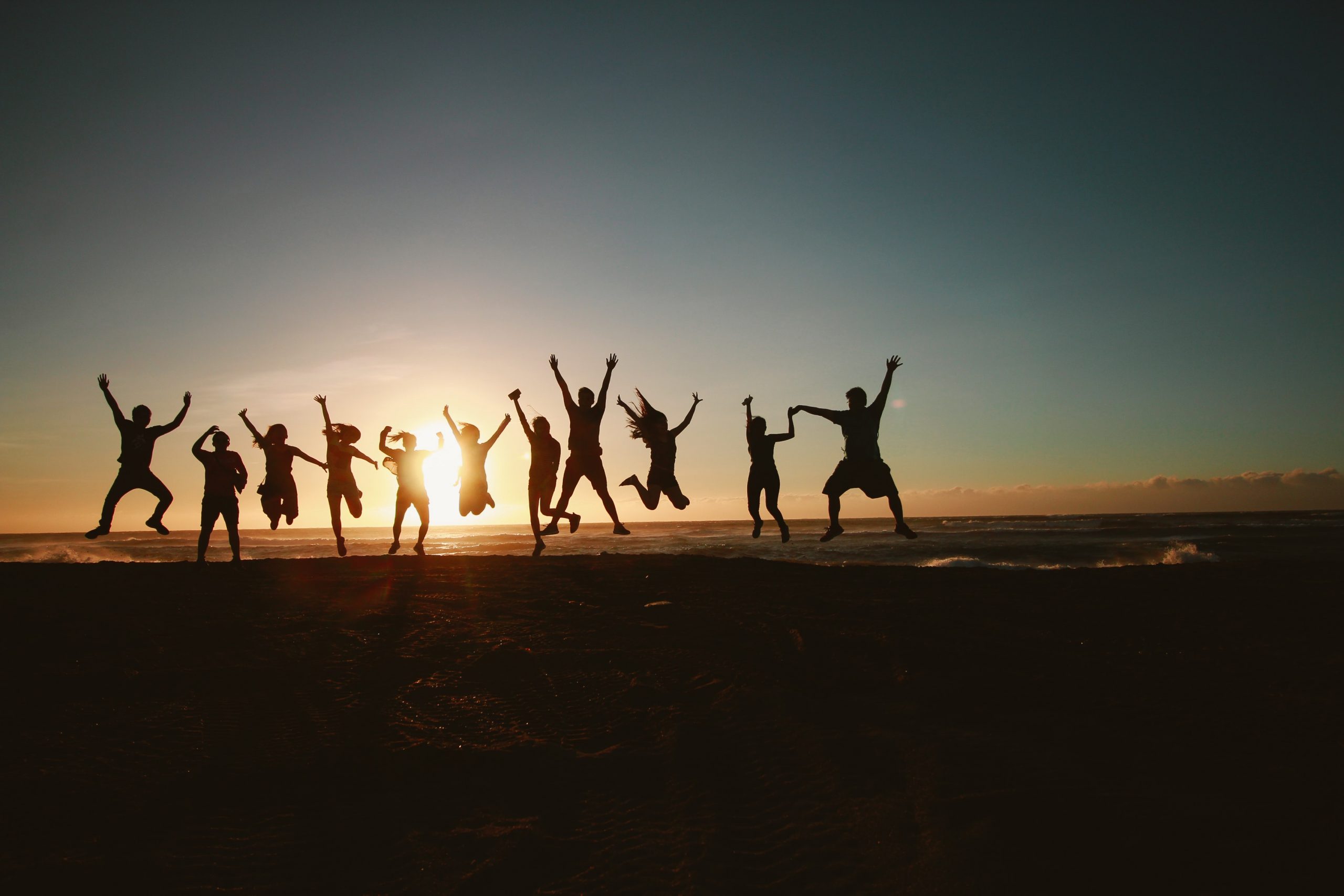 silhouette-photography-of-group-of-people-jumping-during-1000445
