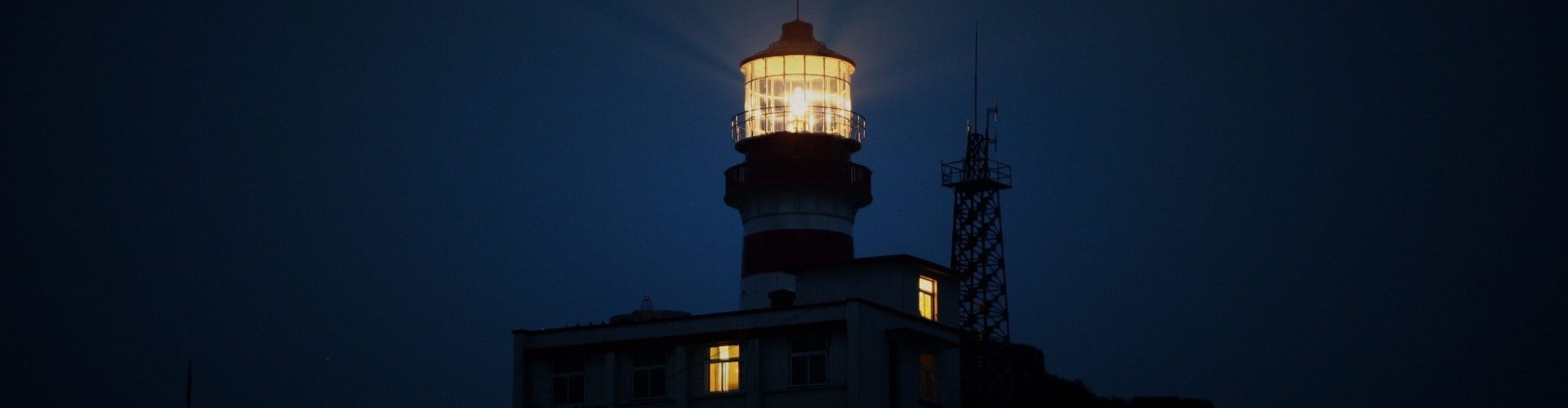 lighthouse-during-night-time-510848